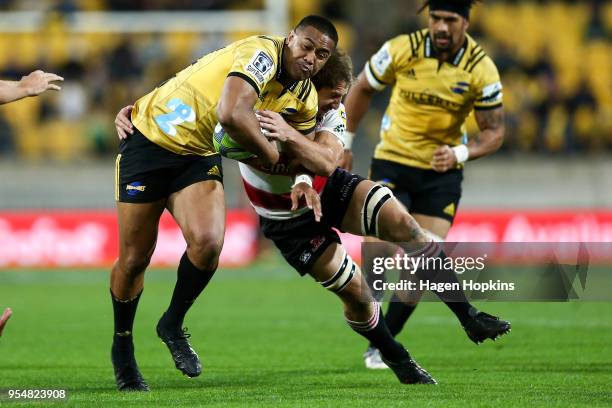 Julian Savea of the Hurricanes is tackled during the round 12 Super Rugby match between the Hurricanes and the Lions at Westpac Stadium on May 5,...