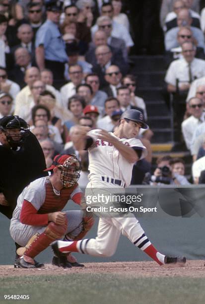 S: Outfielder Carl Yastrzemski of the Boston Red Sox swings and watches the flight of his ball during a MLB baseball game circa 1960's at Fenway Park...