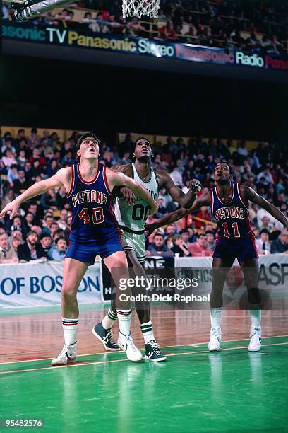 Bill Laimbeer of the Detroit Pistons boxes out against Robert Parish of the Boston Celtics during a game played in 1984 at the Boston Garden in...