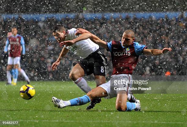 Steven Gerrard of Liverpool is brought down by Luke Young of Aston Villa during the Barclays Premier League match between Aston Villa and Liverpool...