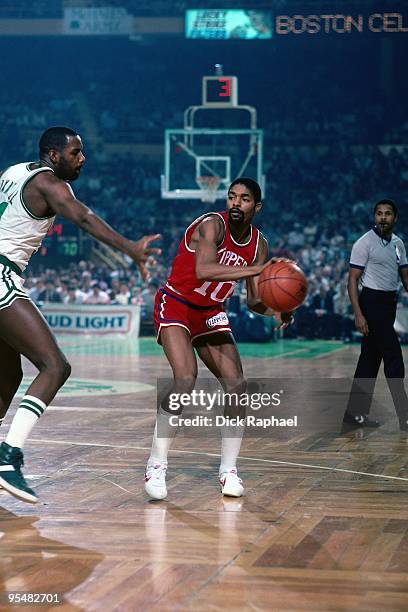 Norm Nixon of the San Diego Clippers looks to pass against Cedrix Maxwell of the Boston Celtics during a game played in 1984 at the Boston Garden in...