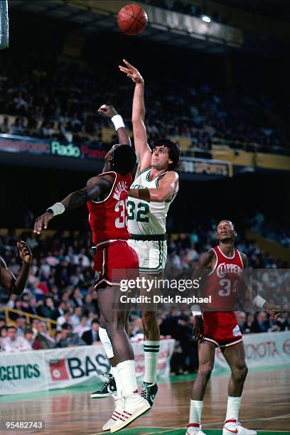 Kevin McHale of the Boston Celtics shoots over Jerome Whitehead of the San Diego Clippers during a game played in 1984 at the Boston Garden in...