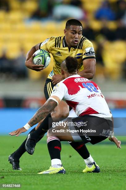 Julian Savea of the Hurricanes is tackled by Elton Jantjies of the Lions during the round 12 Super Rugby match between the Hurricanes and the Lions...
