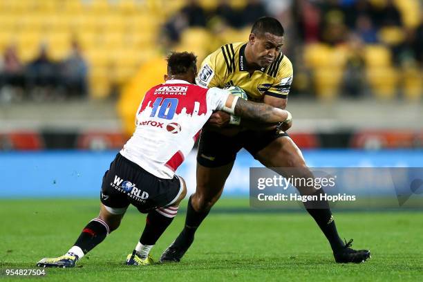 Julian Savea of the Hurricanes is tackled by Elton Jantjies of the Lions during the round 12 Super Rugby match between the Hurricanes and the Lions...