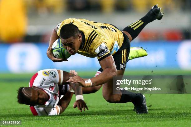 Julian Savea of the Hurricanes is tackled by Elton Jantjies of the Lions during the round 12 Super Rugby match between the Hurricanes and the Lions...