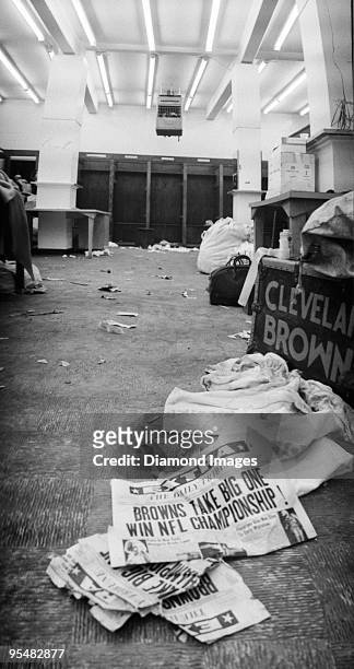 Newspapers with banner headlines on the floor of the lockerroom announce the Cleveland Browns as the champions of the National Football League after...