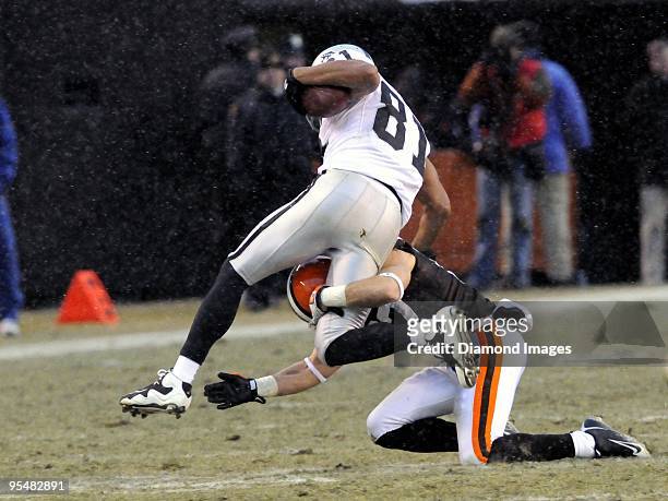 Defensive back Mike Furrey of the Cleveland Browns tackles wide receiver Chaz Schilens the Oakland Raiders during a game on December 27, 2009 at...