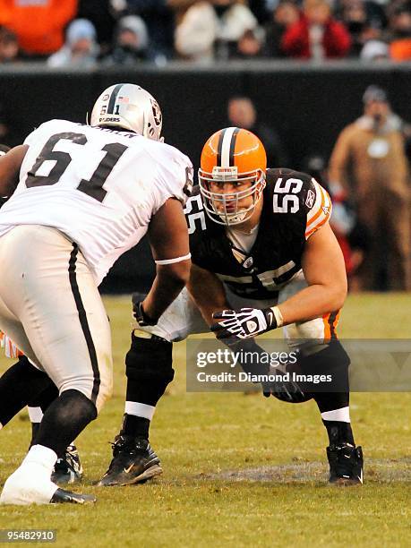 Center Alex Mack of the Cleveland Browns looks at defensive lineman Gerard Warren of the Oakland Raiders while snapping the ball during a game on...