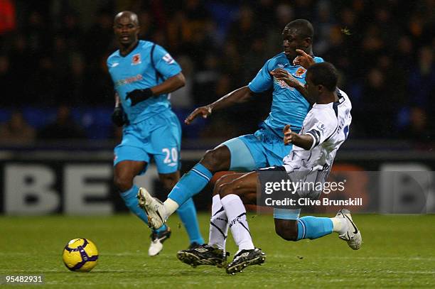 Seyi Olofinjana of Hull City in action with Fabrice Muamba of Bolton Wanderers during the Barclays Premier League match between Bolton Wanderers and...