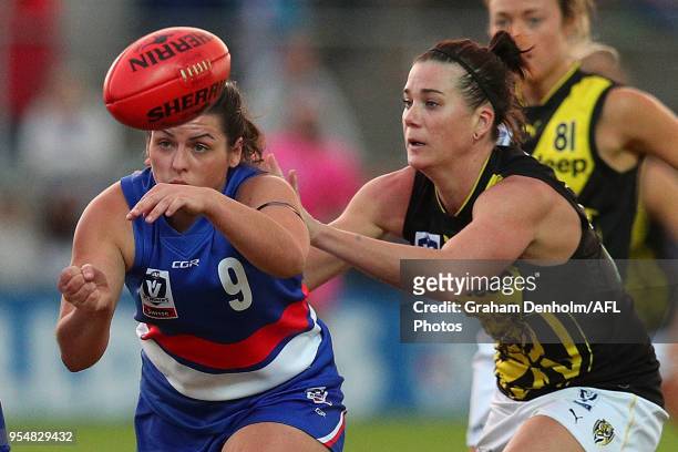 Tayla Dinuccio of the Western Bulldogs handballs during the round one AFLW match between the Western Bulldogs and Richmond at Whitten Oval on May 5,...