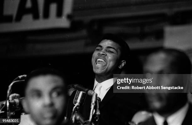 American boxer Muhammad Ali speaks from a lecturn during the Saviour's Day celebrations at the International Ampitheatre, Chicago, Illinois, February...