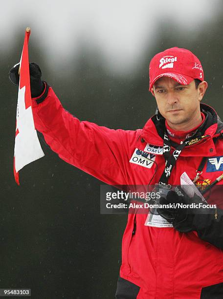 Alex Pointner head coach of Austria lifts the flag for the start during the FIS Ski Jumping World Cup event at the 58th Four Hills Ski Jumping...