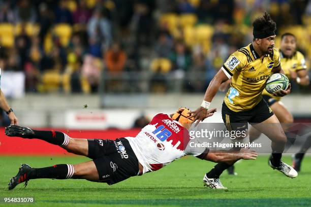 Ardie Savea of the Hurricanes evades the defence of Robbie Coetzee of the Lions during the round 12 Super Rugby match between the Hurricanes and the...