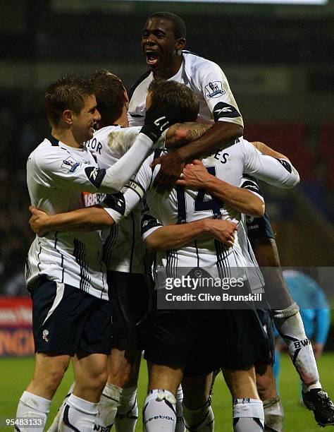 Kevin Davies of Bolton Wanderers is congratulated by team mates after scoring the second goal during the Barclays Premier League match between Bolton...