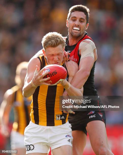 James Sicily of the Hawks and David Myers of the Bombers compete for the ball during the 2018 AFL round seven match between the Essendon Bombers and...