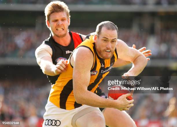 Jarryd Roughead of the Hawks and Michael Hurley of the Bombers compete for the ball during the 2018 AFL round seven match between the Essendon...