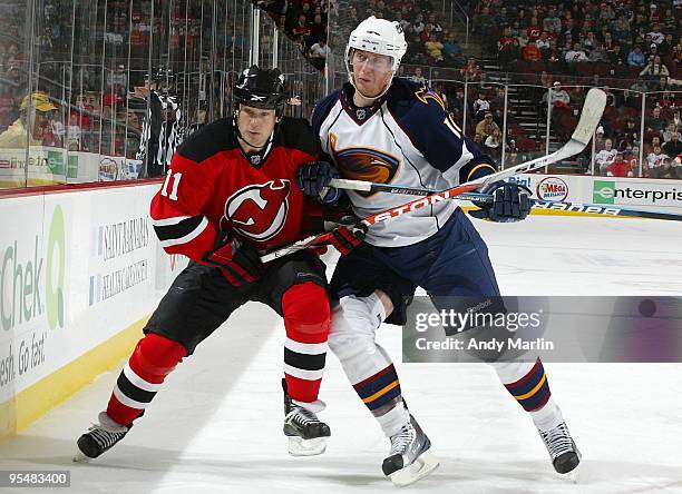 Christoph Schubert of the Atlanta Thrashers and Dean McAmmond of the New Jersey Devils skate for position during the game at the Prudential Center on...