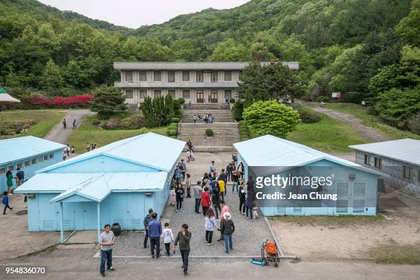 Visitors queue to take pictures at a mock Panmunjeom on May 5, 2018 in Namyangju, South Korea. Namyangju Studios is a film-making studio known for...