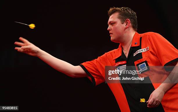 Kevin McDine of England in action against Adrian Lewis of England during the 2010 Ladbrokes.com World Darts Championships at Alexandra Palace on...