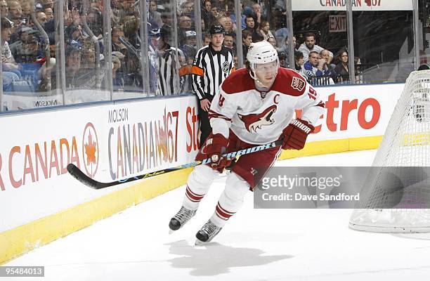 Referee Kevin Pollock watches as Shane Doan of the Phoenix Coyotes skates around the net during their NHL game against the Toronto Maple Leafs at the...