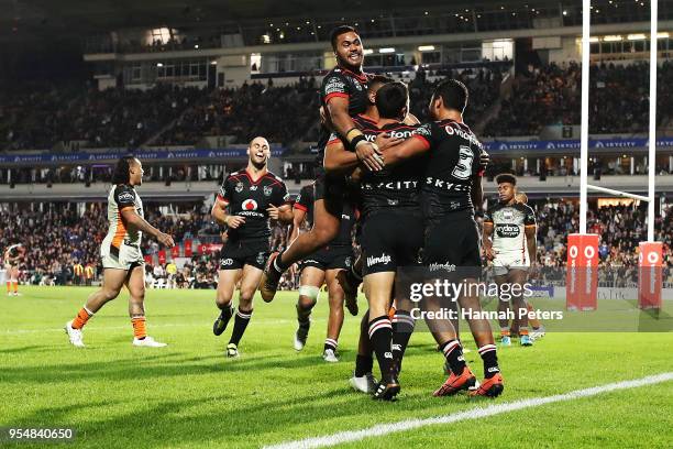 Shaun Johnson of the Warriors celebrates after scoring a try during the round nine NRL match between the New Zealand Warriors and the Wests Tigers at...