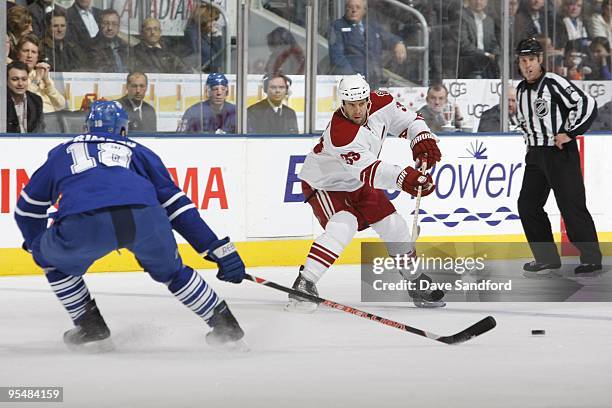 Adrian Aucoin of the Phoenix Coyotes makes a pass play against the Toronto Maple Leafs during their NHL game at the Air Canada Centre on October 16,...