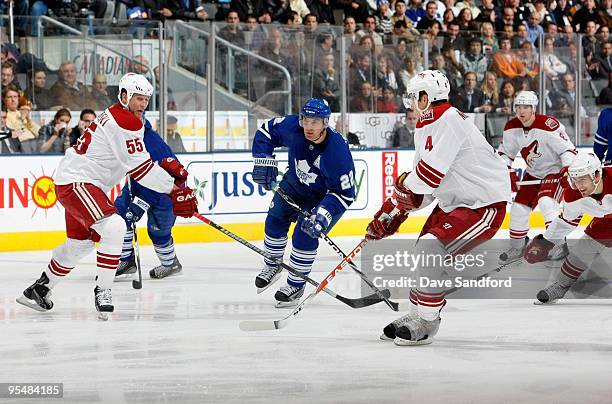 Francois Beauchemin of the Toronto Maple Leafs skates to the net against Ed Jovanovski and Zbynek Michalek of the Phoenix Coyotes during their NHL...