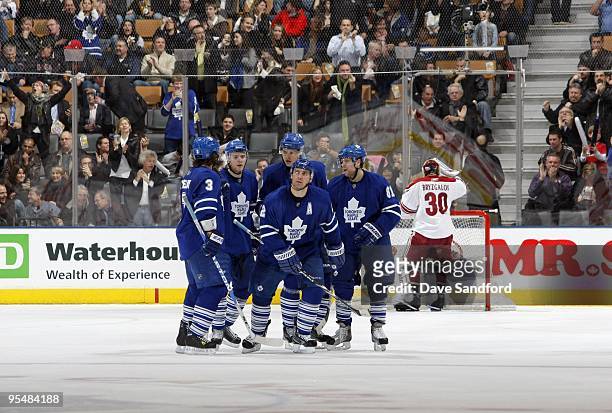 Garnet Exelby, Matt Stajan, Alexei Ponikarovsky, Francois Beauchemin and Phil Kessel and of the Toronto Maple Leafs celebrate after a play during...