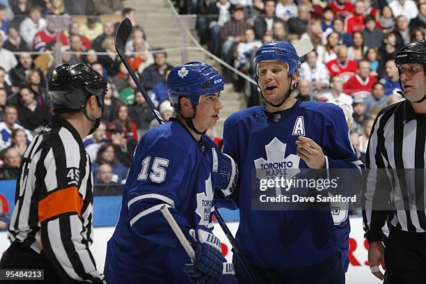 Mike Komisarek of the Toronto Maple Leafs has a word for NHL referee Justin St. Pierre during a break in NHL game action between the Montreal...