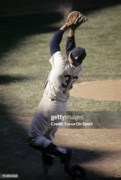 S: Catcher Elston Howard of the New York Yankees fields a foul pop-up behind home plate during a circa mid 1960's Major League Baseball game at...