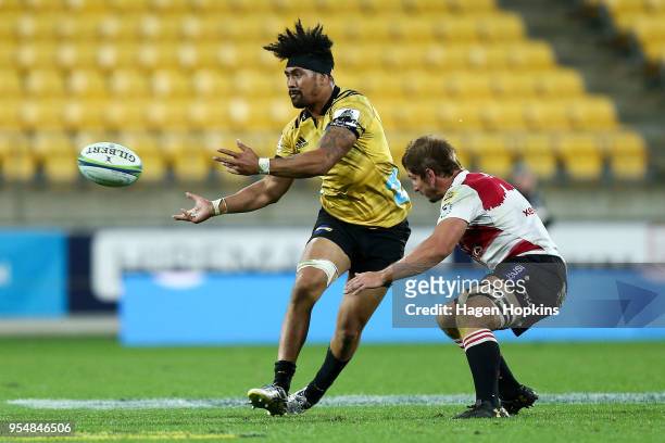 Ardie Savea of the Hurricanes passes under pressure from Kwagga Smith of the Lions during the round 12 Super Rugby match between the Hurricanes and...