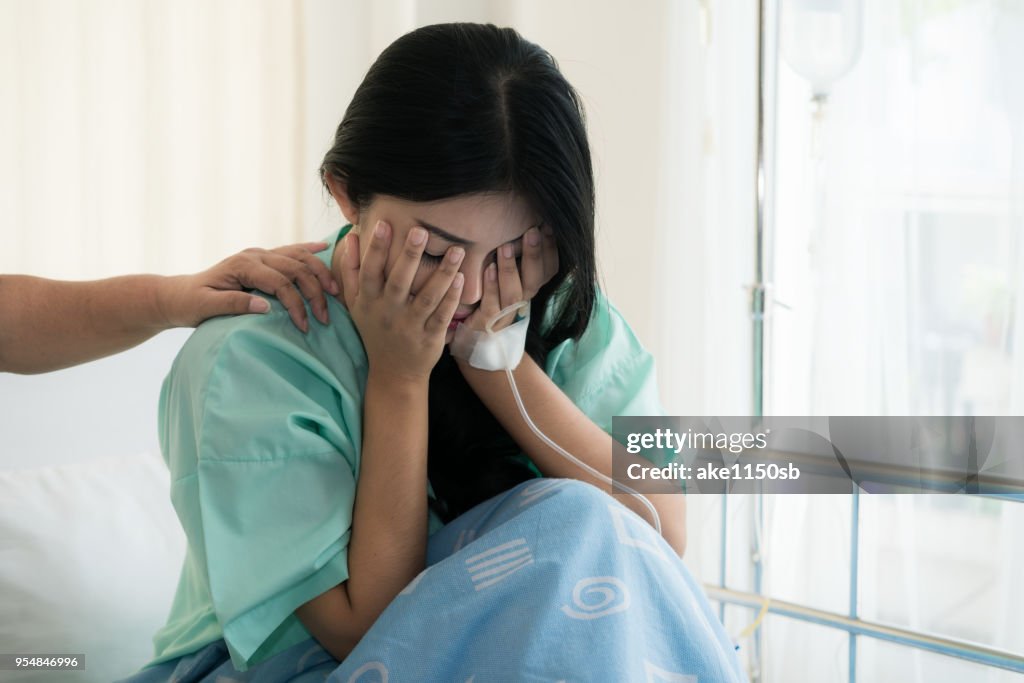 Asian young woman patient receiving bad news, Woman patient is desperate and crying. Her Mother support and comforting her patient with sympathy.
