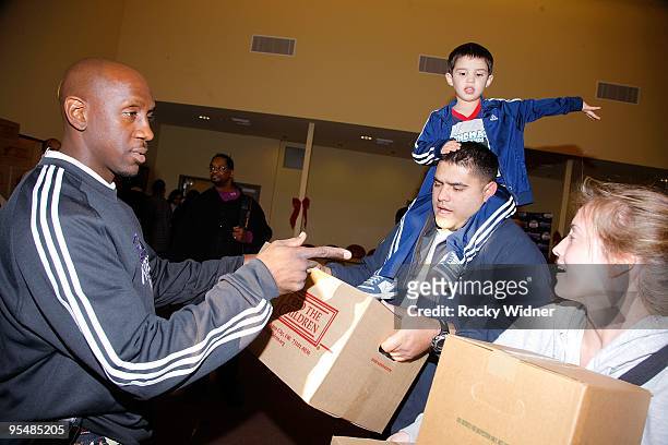Bobby Jackson, formerly of the Sacramento Kings helps feed 400 children and families at the Sacramento Urban League on December 22, 2009 in...