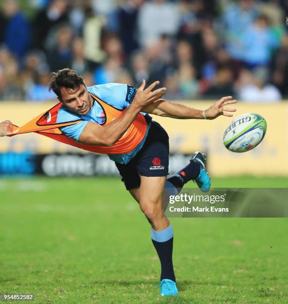 Nick Phipps of the Waratahs passes the ball in the warm up during the round 12 Super Rugby match between the Waratahs and the Blues at Lottoland on...