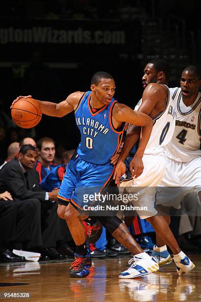 Russell Westbrook of the Oklahoma City Thunder drives against Gilbert Arenas of the Washington Wizards at the Verizon Center on December 29, 2009 in...