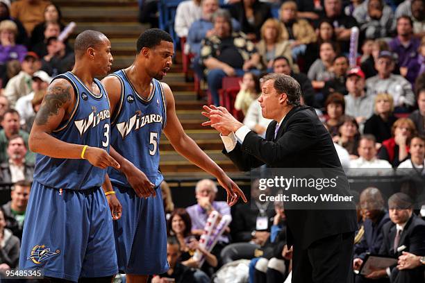 Caron Butler and Dominic McGuire of the Washington Wizards listen to instructions by head coach Flip Saunders during the game against the Sacramento...