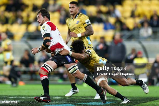 Franco Mostert of the Lions is tackled by Ardie Savea of the Hurricanes during the round 12 Super Rugby match between the Hurricanes and the Lions at...