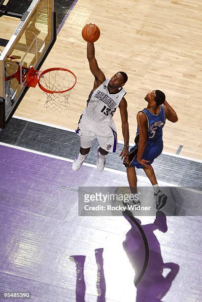 Tyreke Evans of the Sacramento Kings dunks against Dominic McGuire of the Washington Wizards during the game at Arco Arena on December 16, 2009 in...