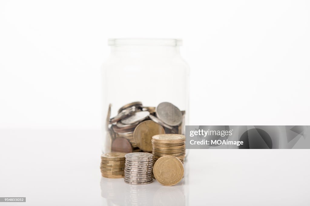 Some coins in a glass bottle