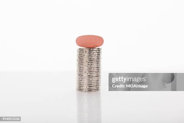 a pill with some coins - nz money stock-fotos und bilder