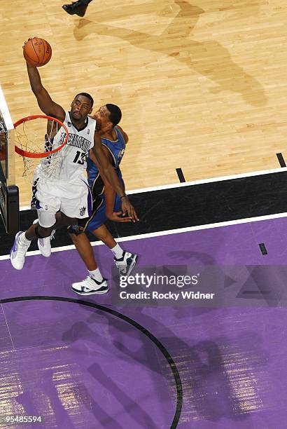 Tyreke Evans of the Sacramento Kings dunks against Dominic McGuire of the Washington Wizards during the game at Arco Arena on December 16, 2009 in...