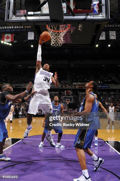 Jason Thompson of the Sacramento Kings shoots a layup against Antawn Jamison and Dominic McGuire of the Washington Wizards during the game at Arco...