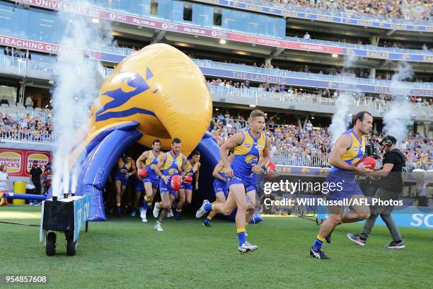 The Eagles run out during the round seven AFL match between the West Coast Eagles and the Port Adelaide Power at Optus Stadium on May 5, 2018 in...