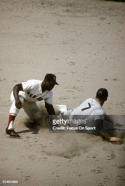 S: Outfielder Mickey Mantle of the New York Yankees steals second base against the Boston Red Sox during a circa 1960's Major League Baseball game at...