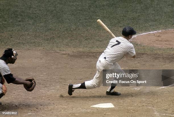 S: Outfielder Mickey Mantle of the New York Yankees swings and watches the flight of his ball during a circa 1960's Major League Baseball game at...