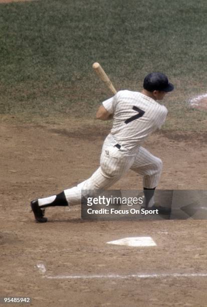 S: Outfielder Mickey Mantle of the New York Yankees swings and watches the flight of his ball during a circa 1960's Major League Baseball game at...