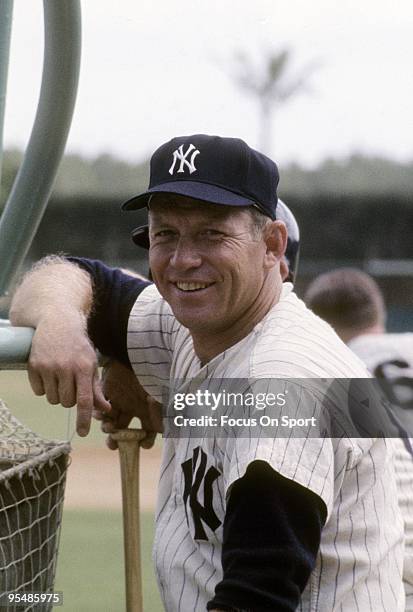 Outfielder Mickey Mantle leaning on the batting cage smiles for the camera in this photo during batting practice before a Major League Baseball...