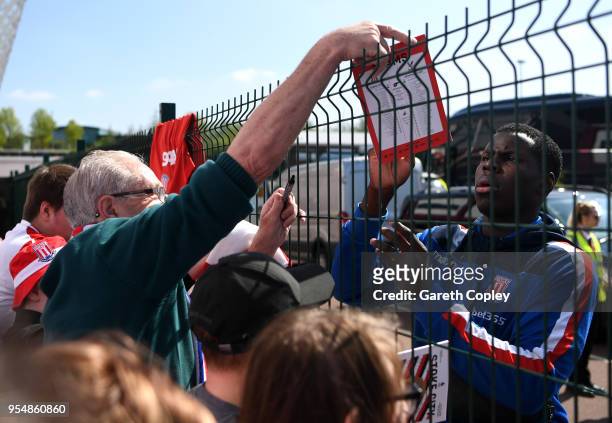 Kurt Zouma of Stoke City signs autographs during the Premier League match between Stoke City and Crystal Palace at Bet365 Stadium on May 5, 2018 in...
