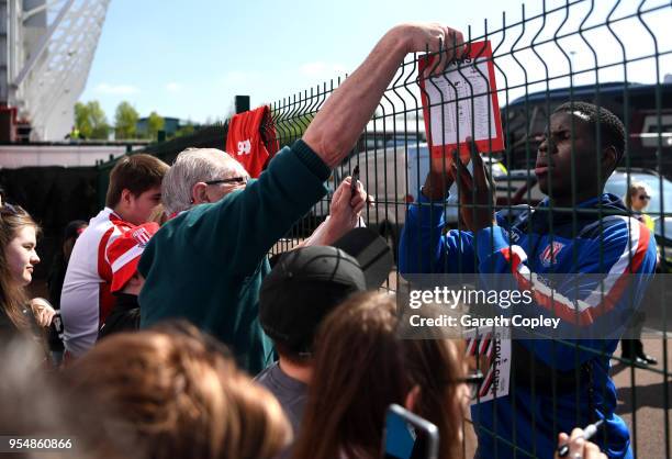 Kurt Zouma of Stoke City signs autographs during the Premier League match between Stoke City and Crystal Palace at Bet365 Stadium on May 5, 2018 in...