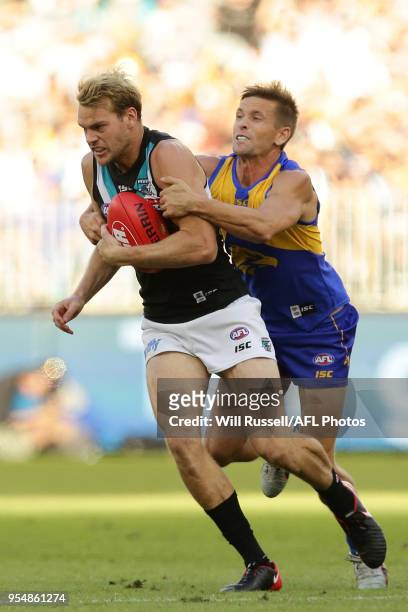Jack Watts of the Power is tackled by Mark LeCras of the Eagles during the round seven AFL match between the West Coast Eagles and the Port Adelaide...